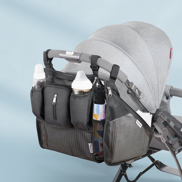 Black mesh stroller organizer attached to a stroller handle, showcasing multiple storage pockets and an insulated cup holder.